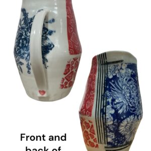 Stunning porcelain vase with intricate hand decoration on surface in red, blue and black.