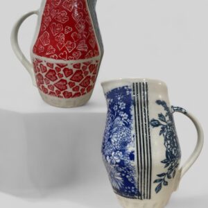 Stunning porcelain vase with intricate hand decoration on surface in red, blue and black.